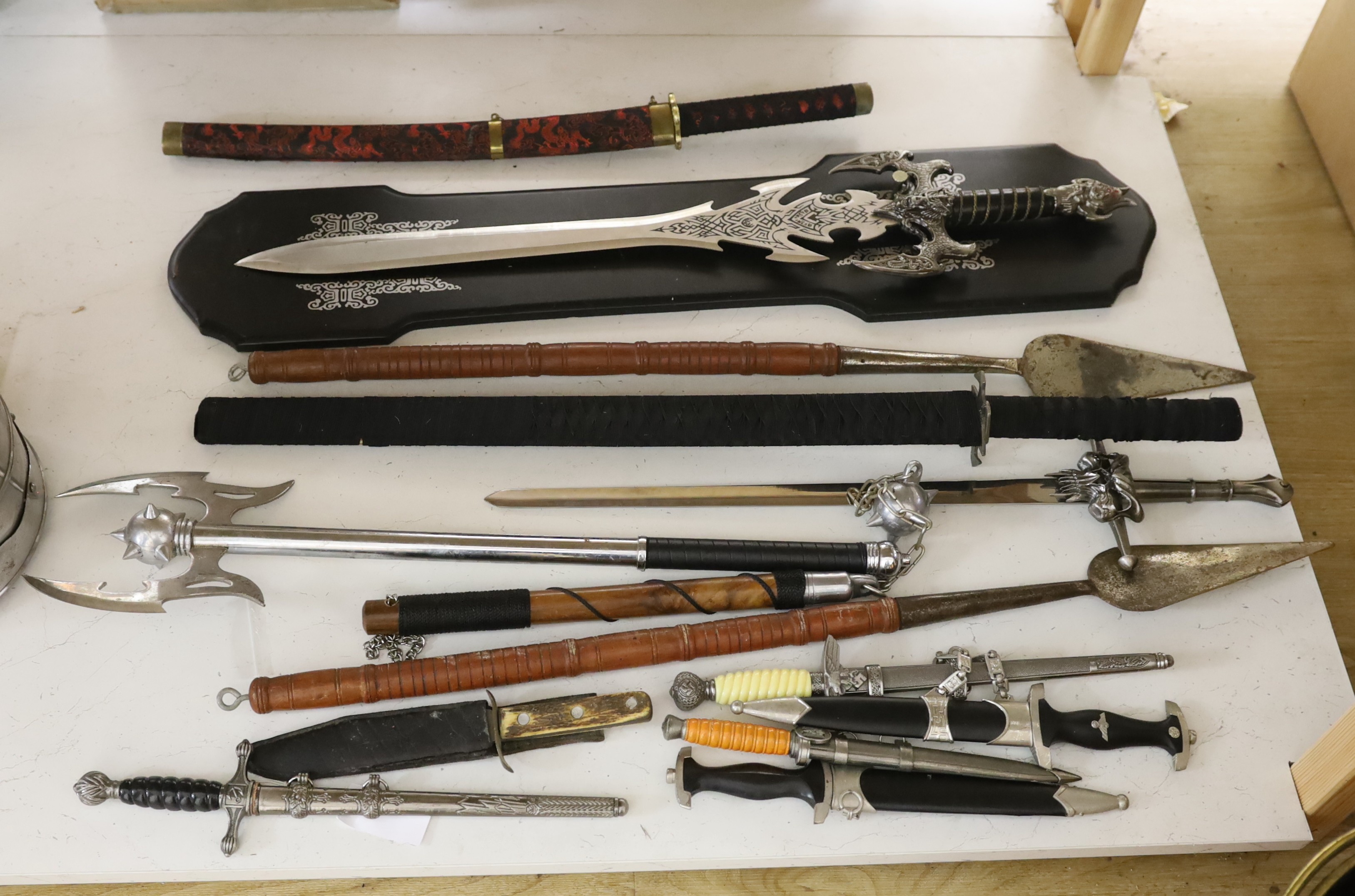 A group of reproduction swords and weapons